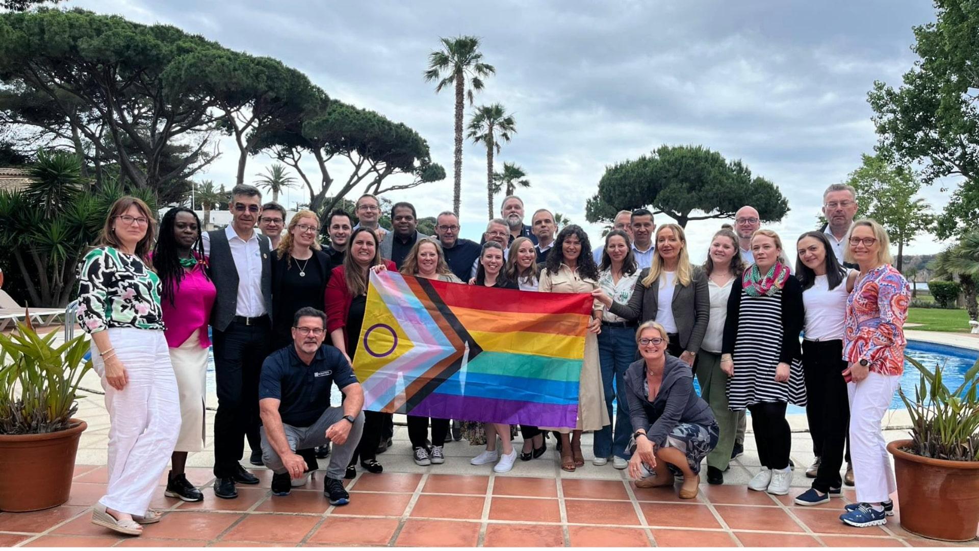 Group of people holding a Pride Flag